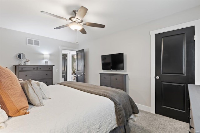 carpeted bedroom with visible vents, a ceiling fan, and baseboards