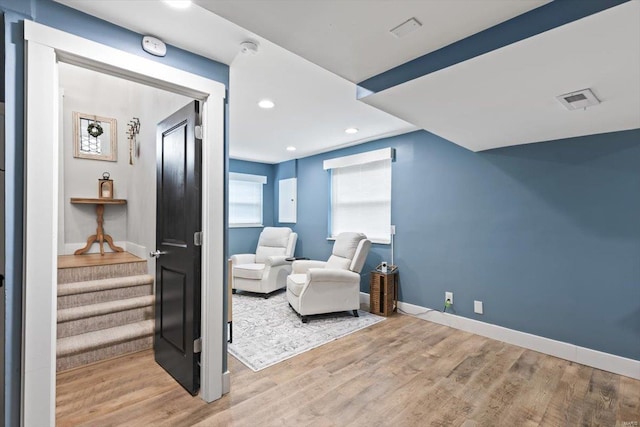 living area featuring stairway, wood finished floors, visible vents, baseboards, and recessed lighting