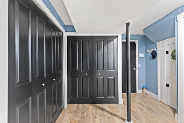 corridor with light wood-type flooring