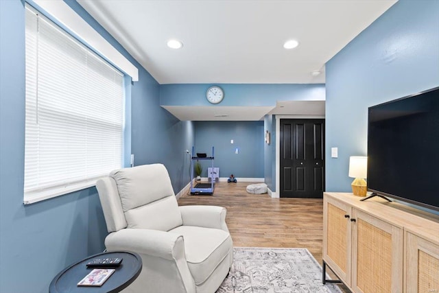 living area with recessed lighting, light wood-type flooring, and baseboards