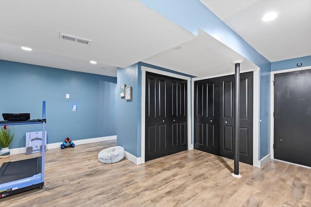 workout area with visible vents, recessed lighting, baseboards, and wood finished floors