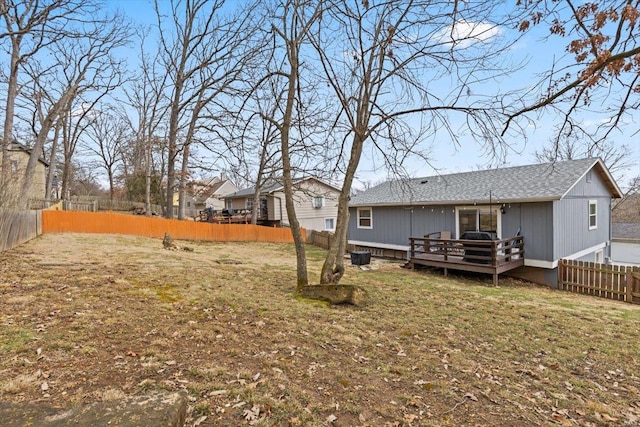 back of house featuring a wooden deck and fence private yard