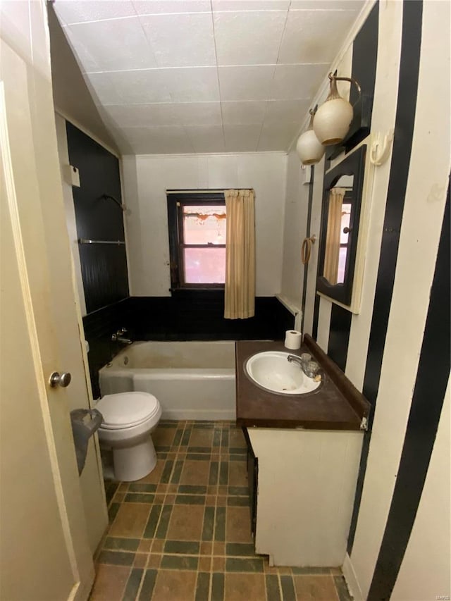 bathroom with toilet, vanity, and a tub to relax in