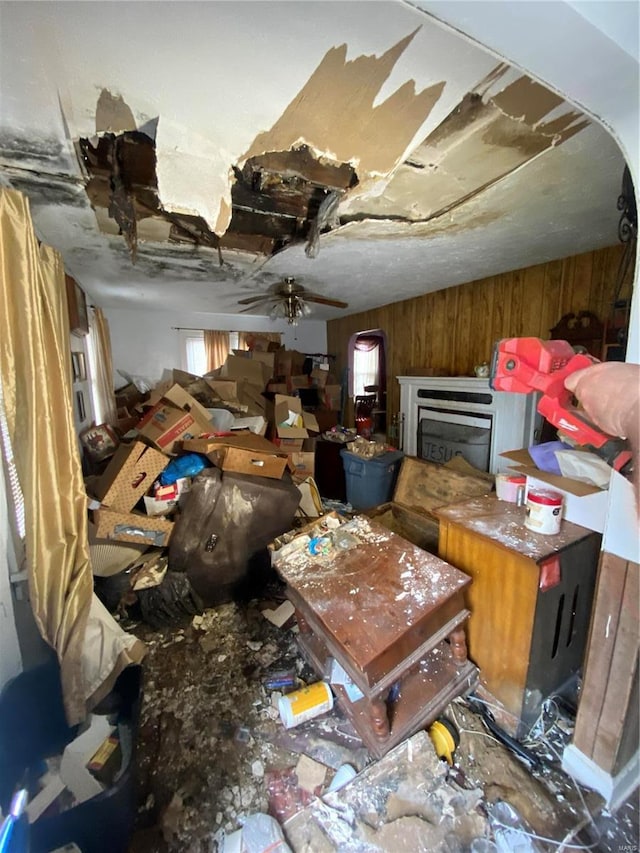 miscellaneous room with wood walls and ceiling fan