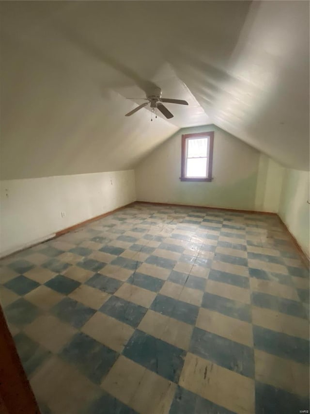 additional living space featuring vaulted ceiling, baseboards, and ceiling fan