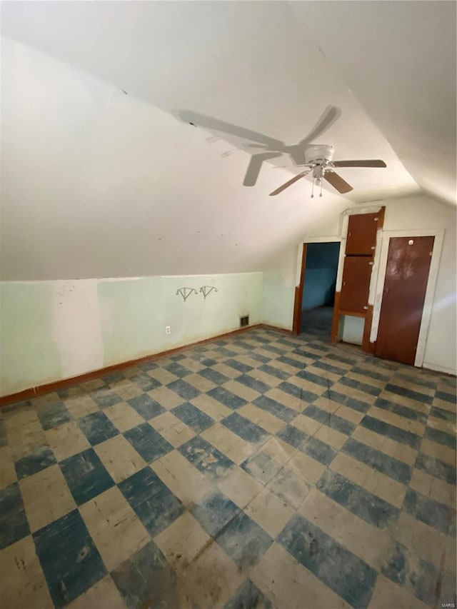 additional living space with ceiling fan and lofted ceiling