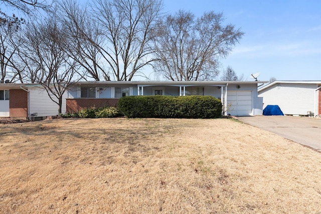 ranch-style home featuring a garage, brick siding, concrete driveway, and a front yard