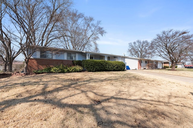 ranch-style house featuring brick siding