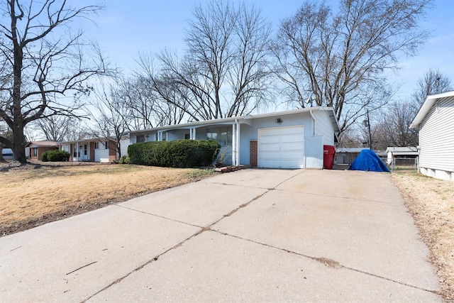 ranch-style house with driveway and a garage