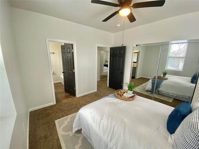 carpeted bedroom featuring ensuite bathroom, a ceiling fan, baseboards, and a closet