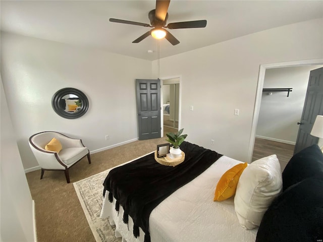 carpeted bedroom featuring baseboards and a ceiling fan