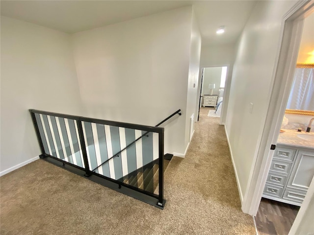 staircase featuring carpet flooring and baseboards
