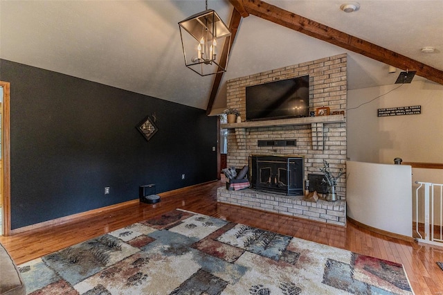 living room with a fireplace, wood-type flooring, vaulted ceiling with beams, and baseboards