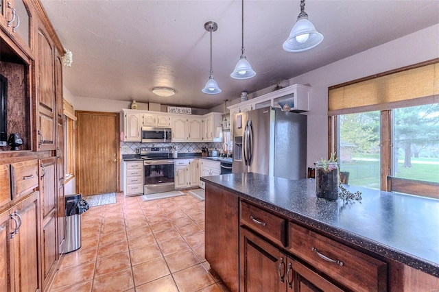 kitchen featuring light tile patterned floors, dark countertops, stainless steel appliances, backsplash, and pendant lighting