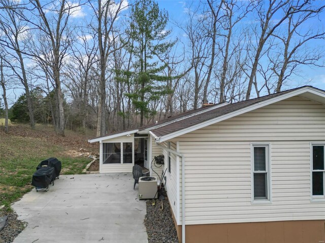 view of home's exterior with a patio area and a sunroom