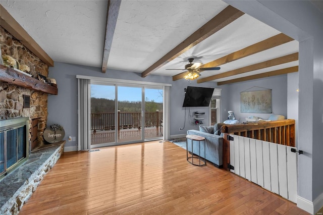 living room featuring baseboards, ceiling fan, and hardwood / wood-style flooring