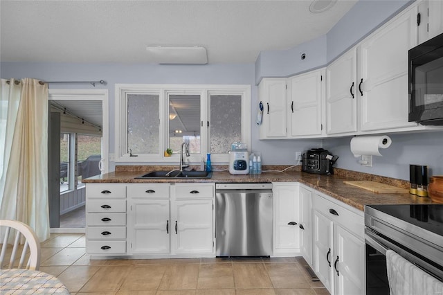 kitchen featuring white cabinets, appliances with stainless steel finishes, and a sink