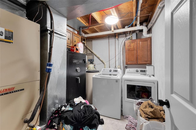 laundry room featuring laundry area, heating unit, and independent washer and dryer