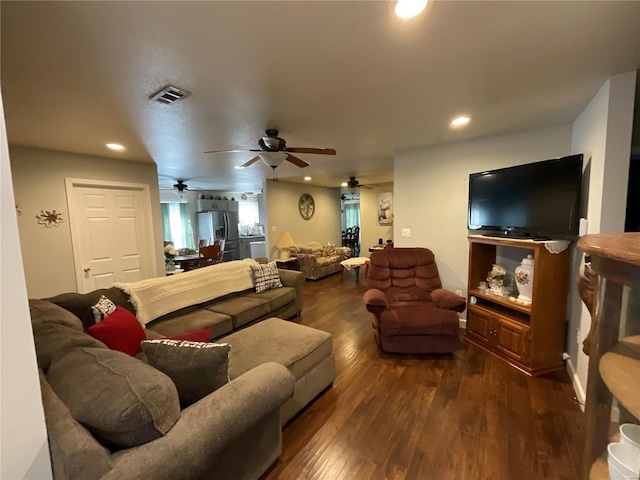 living area featuring ceiling fan, visible vents, recessed lighting, and dark wood finished floors