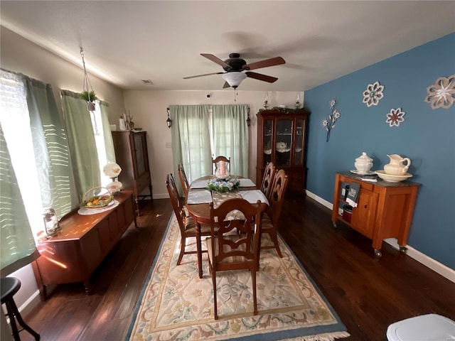 dining space featuring a ceiling fan, baseboards, and wood finished floors