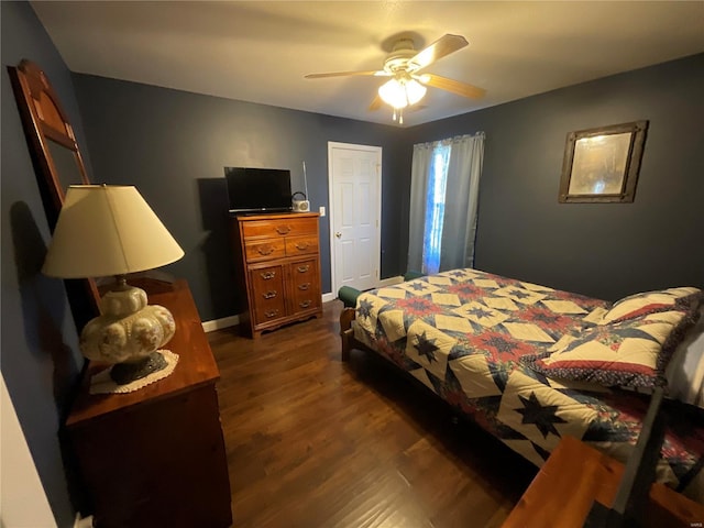 bedroom with a ceiling fan, dark wood-style floors, and baseboards
