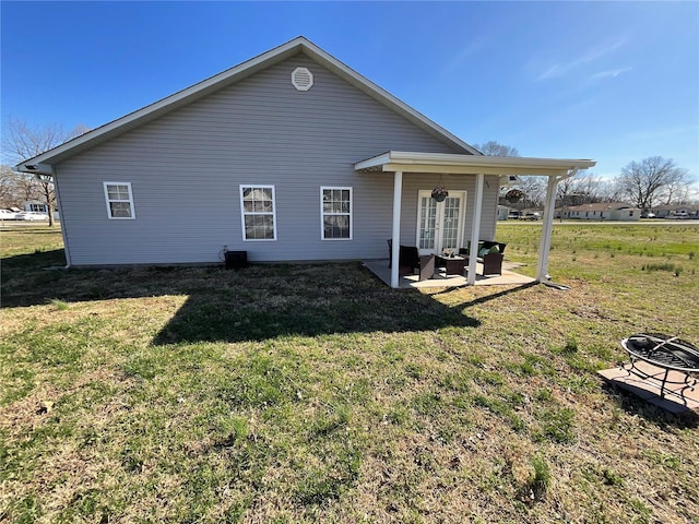 rear view of property with a patio and a yard