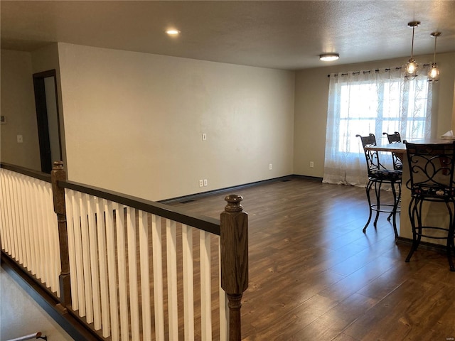 interior space featuring dark wood-type flooring, recessed lighting, and baseboards