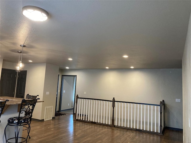 interior space featuring recessed lighting, visible vents, baseboards, and dark wood-style floors