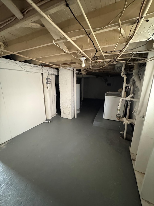 unfinished below grade area with gas water heater and washer / dryer