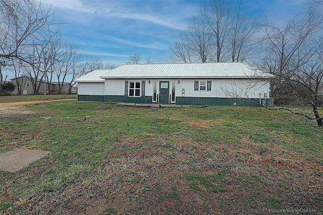 manufactured / mobile home featuring a front lawn, central AC unit, and metal roof