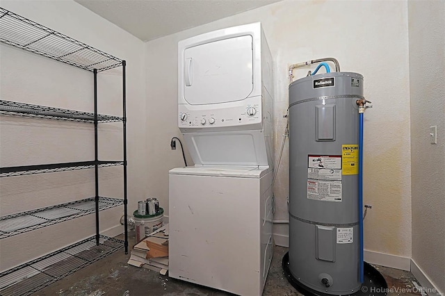 washroom featuring laundry area, baseboards, stacked washer and clothes dryer, and water heater