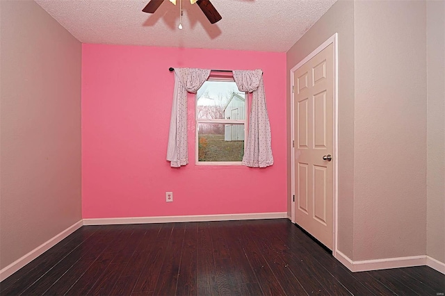 spare room featuring baseboards, a textured ceiling, a ceiling fan, and hardwood / wood-style flooring