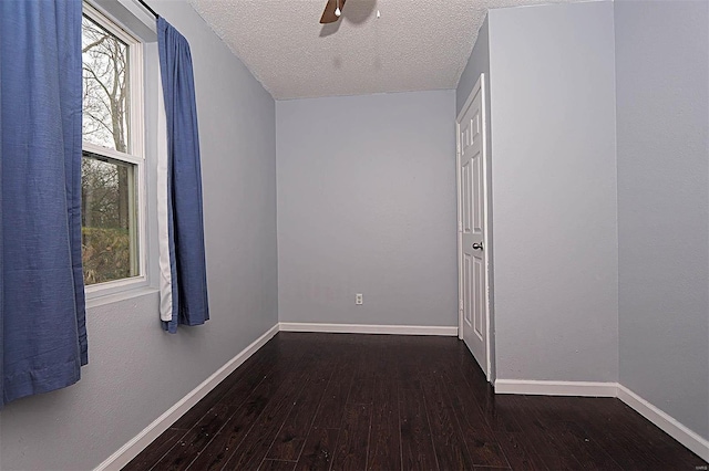 spare room featuring baseboards, a textured ceiling, ceiling fan, and hardwood / wood-style flooring