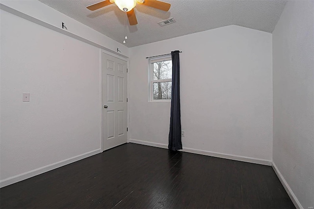 empty room featuring visible vents, baseboards, ceiling fan, dark wood finished floors, and a textured ceiling