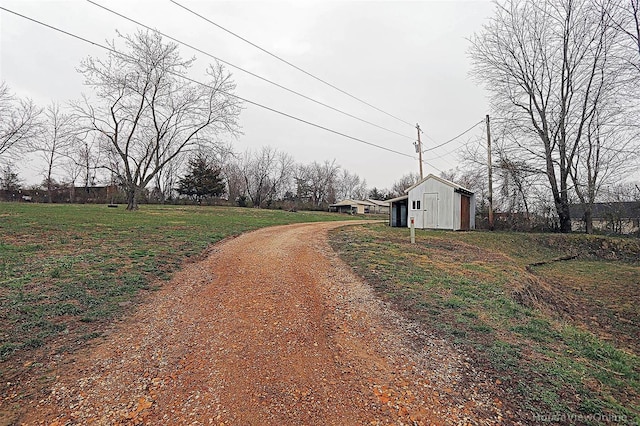 view of street with an outbuilding and driveway