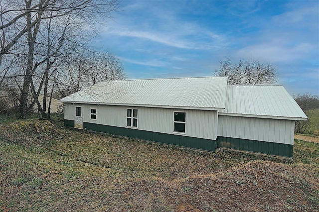 view of side of home with metal roof