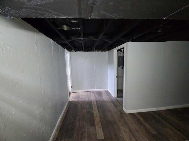 unfinished basement with baseboards and wood finished floors