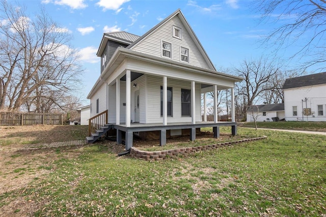 view of front of house featuring a front yard, a porch, and fence