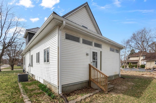 view of property exterior with central AC unit and entry steps