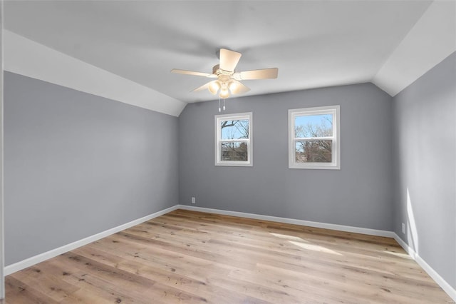 additional living space featuring baseboards, light wood-style floors, lofted ceiling, and ceiling fan