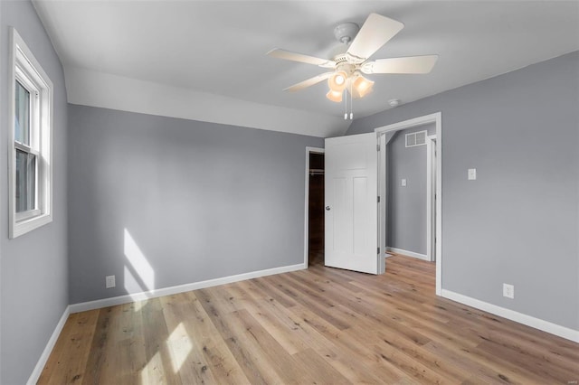 unfurnished bedroom with a ceiling fan, baseboards, visible vents, light wood-style flooring, and a closet