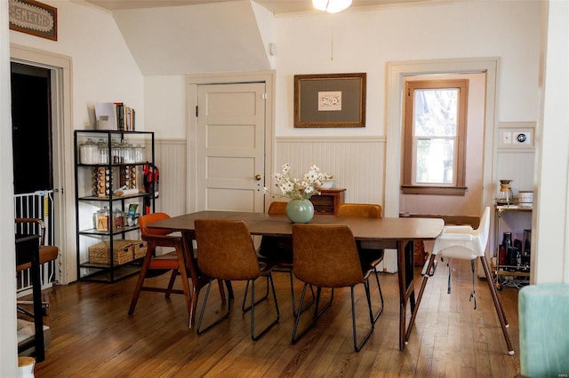 dining area featuring hardwood / wood-style floors and a wainscoted wall