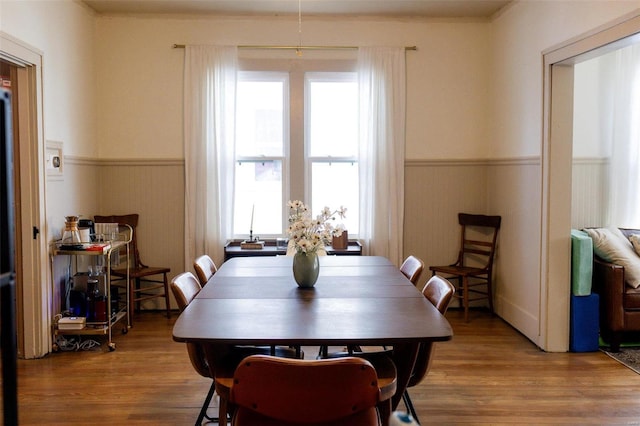 dining room featuring a wainscoted wall and wood finished floors