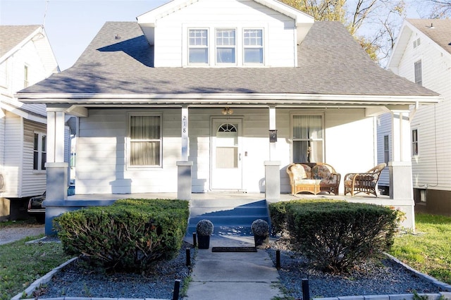 bungalow-style home featuring a porch and a shingled roof