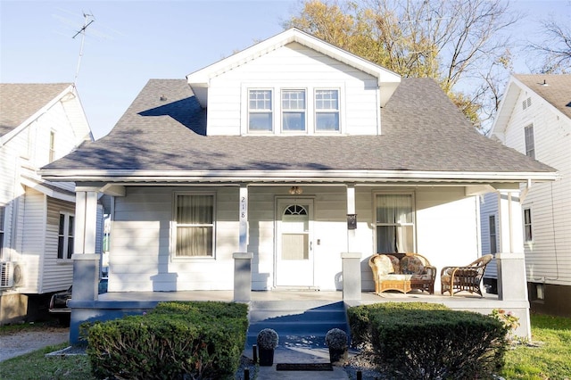 bungalow-style home featuring a porch and roof with shingles