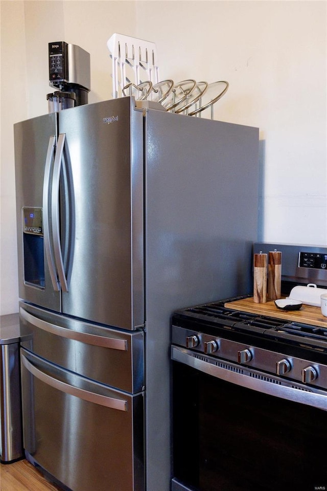 kitchen with appliances with stainless steel finishes and light wood-style flooring