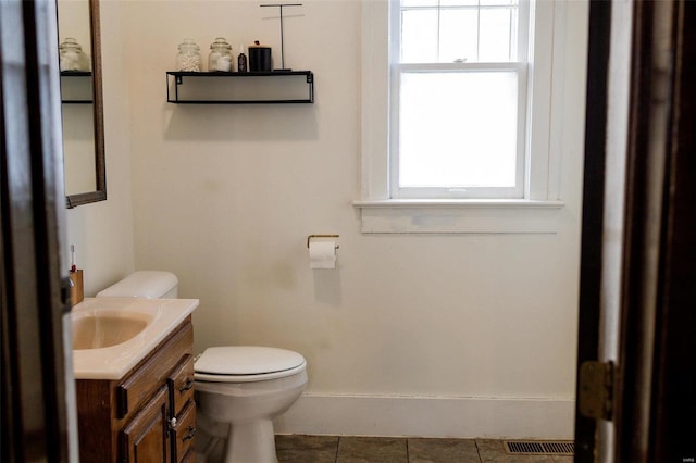 bathroom with a wealth of natural light, visible vents, toilet, and vanity