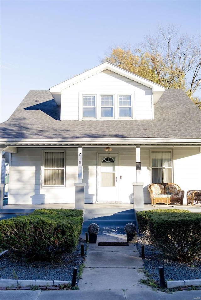 view of front of property with an outdoor hangout area, roof with shingles, and covered porch