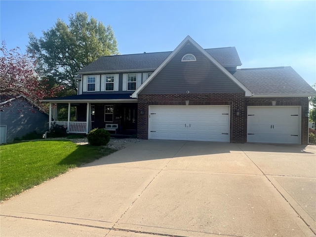 traditional home with a front lawn, brick siding, concrete driveway, an attached garage, and a porch
