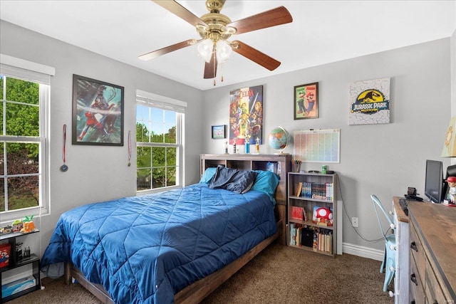 carpeted bedroom featuring a ceiling fan and baseboards